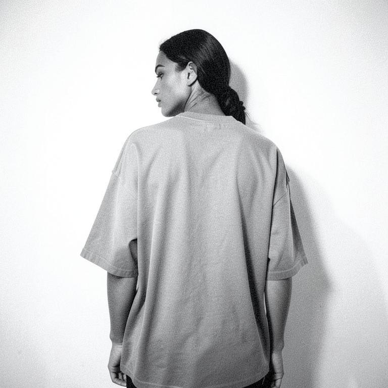 Model wearing an oversized tee, shot from behind